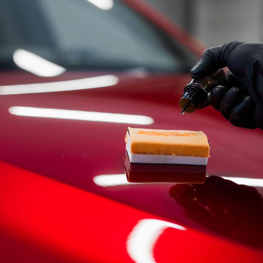 Car detailing - Man applies nano protective coating or wax on red car. Covering car bonnet with a liquid glass polish SSUCv3H4sIAAAAAAAACnRSy47cIBC8R8o/WJxjyTb4tdecI+1hb9EeGozHaBiwAG8SrebfA8aMSTa5QVV3Vb/eP38qCkTBCoaeivfw838h5WadASe08nD15cANVxM3OcIn4bQRIHOQgmOLghv3oNqkDPB9J5F14DbLbWZml805bqzT7OrhOqms4qeDHKDisgeti3Y6J+oGmzkAmREDxy++sj+sUp/f479IxE76DE+hFwPKrtq42P3hESvdaIj4CsaiBEe7/2g9c71K/i+Nb8IyLiUorrdMLD5eU2Nw4Yr9OhsIyob7wt74DcyVu7yXMIiH0mt83LOJGC45xNEfOQhD3XfjPJTQ9Lgkw9iV40xoiXtMJ0oZnVm7S8aK0PWHX9Rtn+ghCtskdDbhN81AhgCcOa9GMKEuWZp2y35HKY3pTTkTOkV136aBIan1CtRP8KmYvSxP+ALW+owp4fne/eHqW2altNt7RlEVTf4wdh/ckK4j1dDhltS4HskREE90EV5nryjVuK1Sw8SD6bmOv4+3q5q666uGPHZ+3nHkatKf3IeTPmLa8Yx5XPfBDeTjbncRMeWbEaFQNPdtT6quKxljdUmANOVIeVNiNswVUDywofcbvv8GAAD//wMAF0VmdAgEAAA=